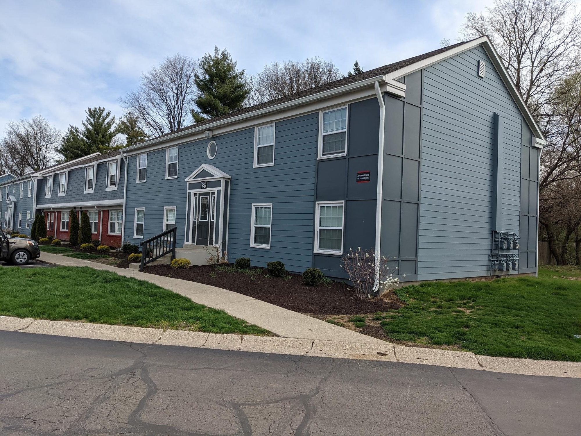 Renovated garden-style apartment exterior with new siding