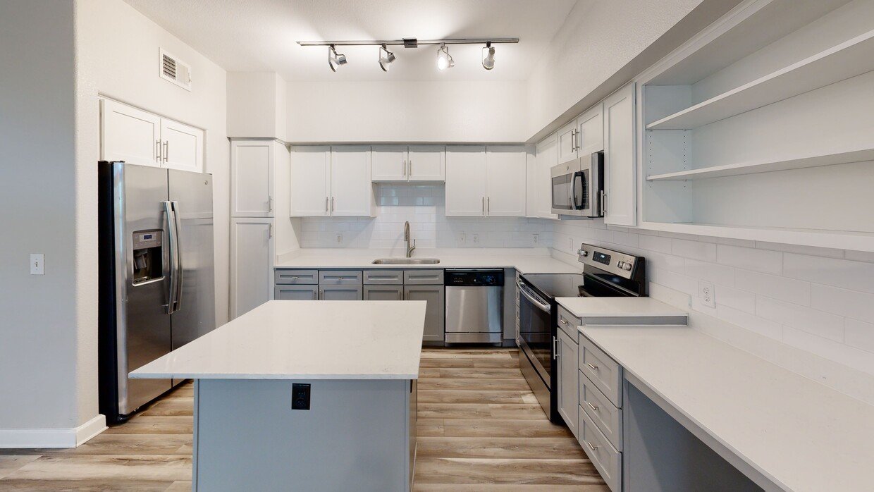 Grandview Apartments renovated kitchen with island and white shaker cabinets