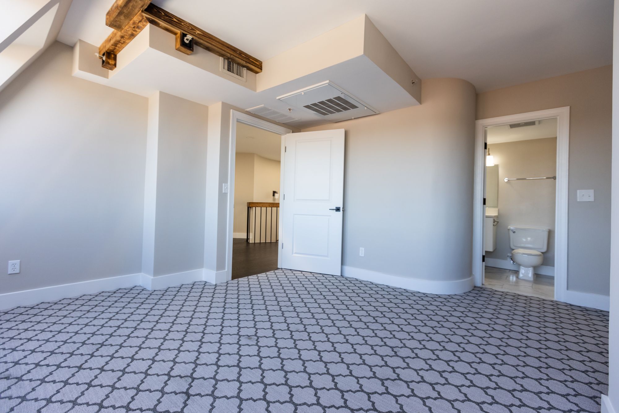 Georgetown Suites renovated apartment with exposed beam and patterned tile floor